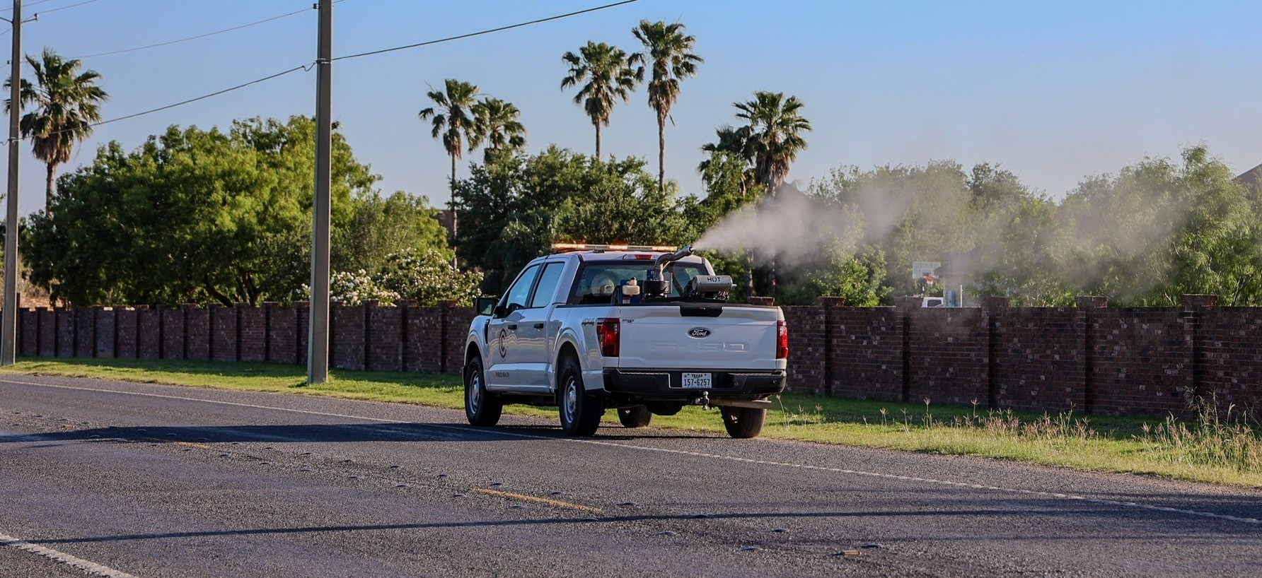 Photograph of a Cameron County truck spraying the streets.