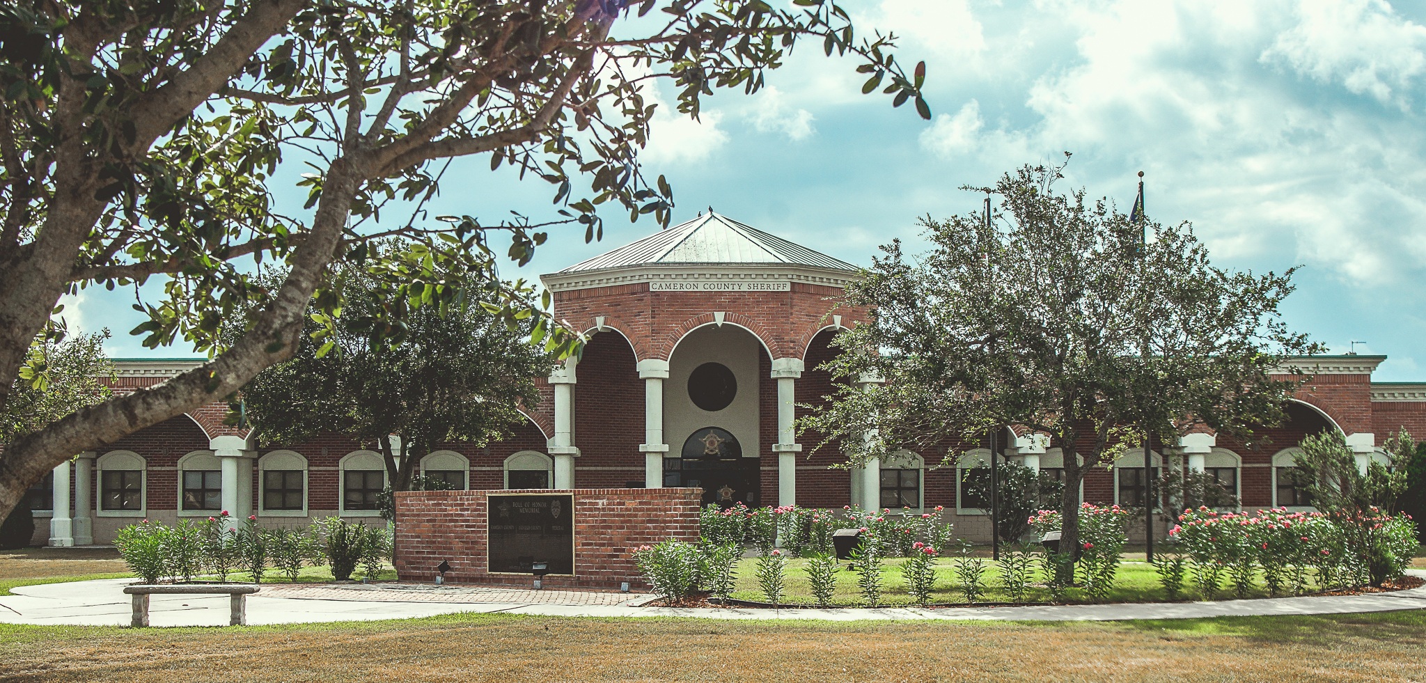Sheriff main building entrance with trees and flowers in the area